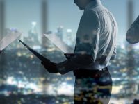 businessman with paper standing in night office