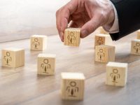 Customer-Managed Relationship Concept - Businessman Arranging Small Wooden Blocks with Symbols on the Table.